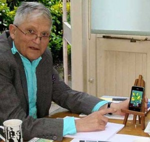 David Hockney next to an iPhone on an easel with his drawing displayed