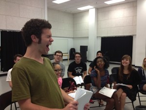 Trevor Catalano as "Tommy" in the rehearsal room with cast and band.