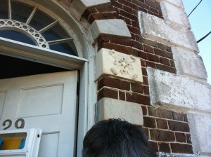 Close up of the quoins and fanlight over the front entry.