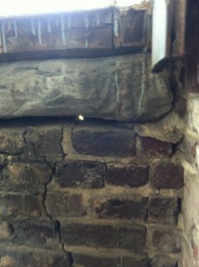 One of surprisingly few cracks in the masonry, and a stone window sill.