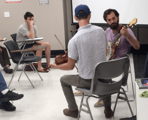 Fiddle and banjo players in classroom