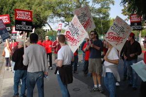 A crowd of union members holding signs
